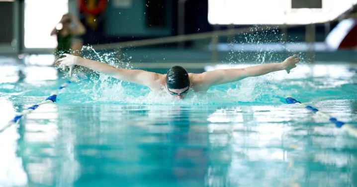 man swimming in a pool (doing exercise not free swimming)