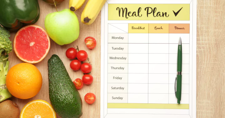 meal plan book with fruits and vegetable put on the right