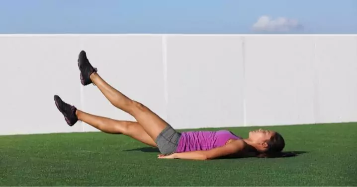 woman outdoor performing flutter kicks exercise